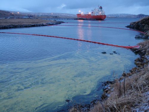 Booms contain oil in Adak Bay after a spill.
