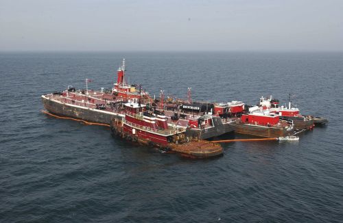 Tug boats assist in the response to Bouchard Barge No. 120.