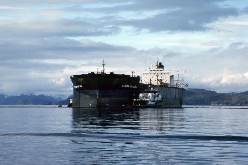 The Exxon Valdez aground; tug assisting in response.