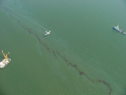 Dispersant being applied to spilled oil by air.