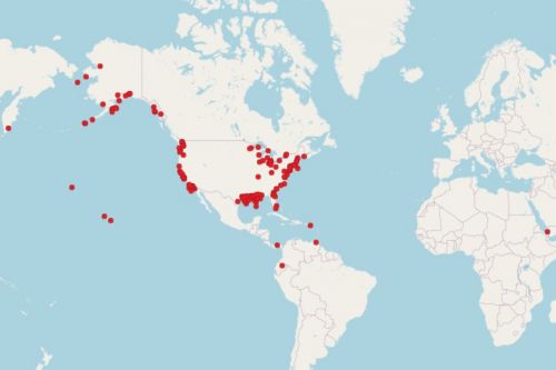 A map of the globe with red dots on it. 