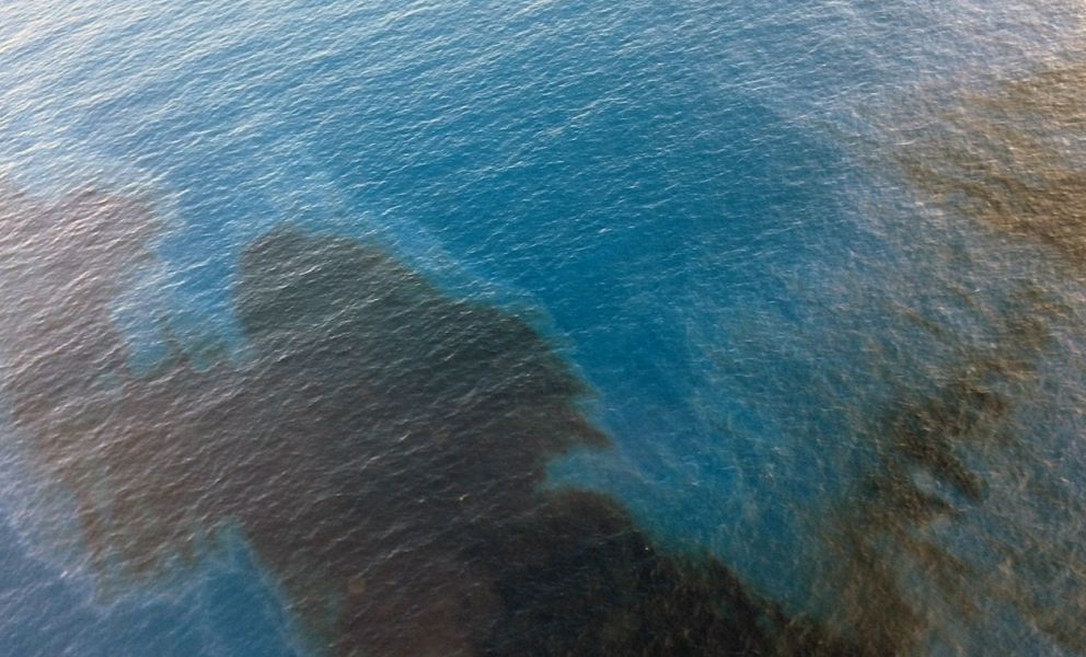Aerial view of oil slick on water.