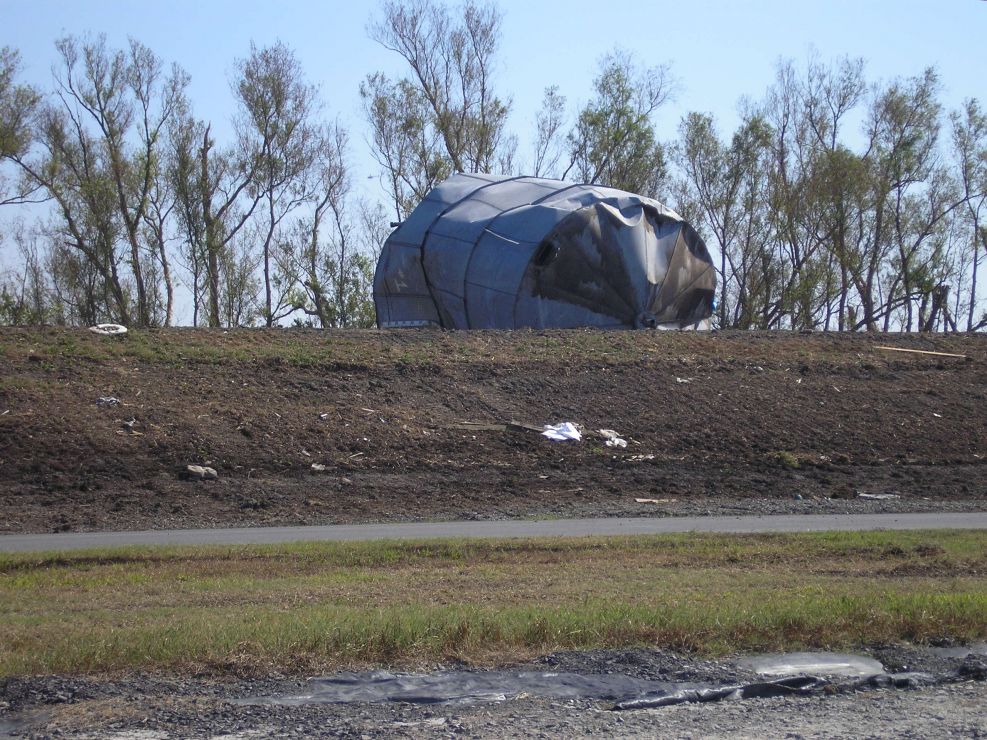 Tank overturned on a levee.