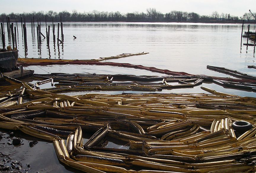 Oiled boom collected by the edge of the river.