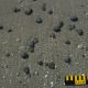 Photo: Round tarballs on sand.