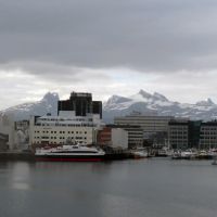 Seaport with snow-capped mountains in background.