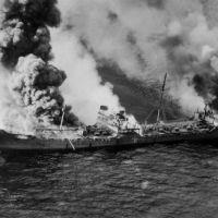 A black and white photo of smoke billowing from a vessel.