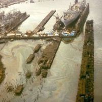Ships in drydock; oil slicks all around dock area. 