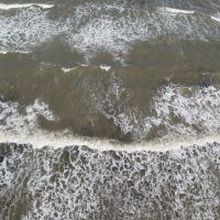 Overhead view of oil in the surf.