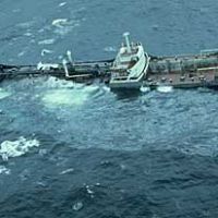 A large ship sinking in the ocean.