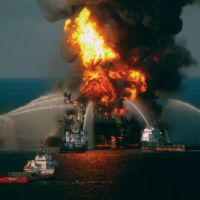 Deepwater Horizon oil rig on fire in Gulf of Mexico with firefighting boats.