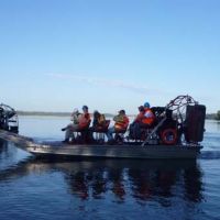 A scientific team monitors cleanup progress in an airboat on the Kalamazoo River