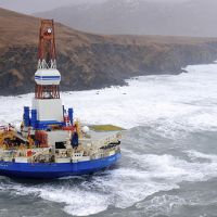 Rocky coast and habitats adjoin the grounded conical drilling unit Kulluk.