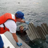 Photo: A diver retrieves a piece of debris from the 2011 Japan tsunami.