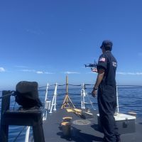 USCG UAS pilot, onboard the USCG Cutter Blackfin, completes a test flight by catching a drone after its flight over an oil slick off the Santa Barbara Coast. (Image Credit: NOAA). 