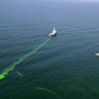 A vessel releases nontoxic green dye off San Francisco during a 2006 drill.
