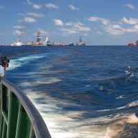National Geographic videographer Bob Perrin films an oil slick at the Deepwater Horizon site.