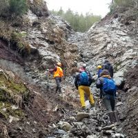 Scientists inspect the headwall at landslide site in Alaska.