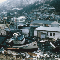 A scene of the chaotic condition of the commercial section of Kodiak following inundation by seismic sea waves.