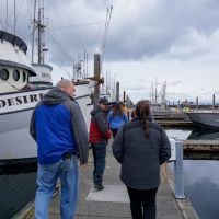 OR&R Director Scott Lundgren and staff from the NOAA Marine Debris Program walking the docks at the Makah Marina to inspect the vessels that have been identified for removal. 