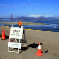 A sign indicating a closed beach.