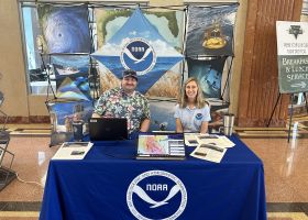 Two OR&R staff at a NOAA informational booth at the Hurricane Awareness Tour. 