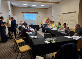 Several agencies and private industry participants around a table as part of the offshore wind spill exercise held October 2, 2023. Image credit: NOAA.