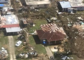aerial image of debris and damaged houses following extreme weather event