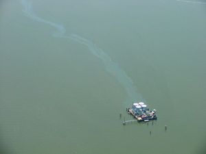 An overflight team discovers a pollution source during their pollution assessment following Hurricane Gustav. Image Credit: LDEQ