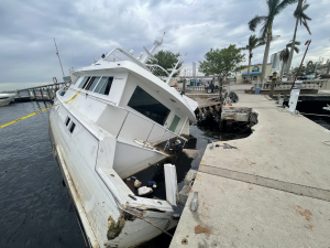 A common scene in the wake of Ian’s destruction, a sunken vessel and damaged dock in Fort Myers Yacht Basin. Image Credit: NOAA/William Witmore 