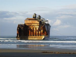 A view from shore of the bow section of the M/V New Carissa as it rests in the surf off Coos Bay, Oregon. Image Credit: USCG