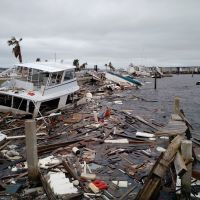 Hurricane debris, including a derelict vessel in a body of water.