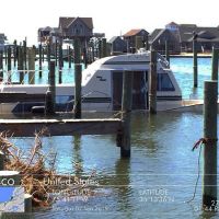 Sinking boat near a dock.