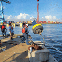 A large piece of equipment being deployed from a dock. 