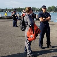 Two people conversing on a dock. 