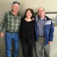 Three people posing for photo.