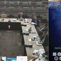 On the left, people sitting around a table; on the right, conference banner.