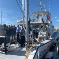 Group of people talking on a vessel.