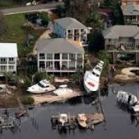 Overhead view of houses on the water, docks and boats.
