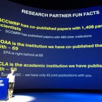 Text projected on a screen, "NOAA is the institution we have co-published the most papers with — 69. 