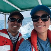 Two people on a boat smiling.