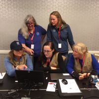 Five people working at a table.