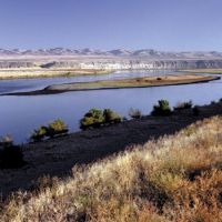 Riverbank, river, and mountains.