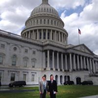 Two men in front of U.S. Capitol.