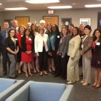 Group of about 20 people in a conference room.