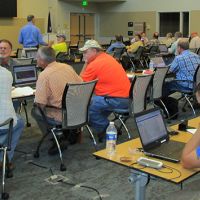 Men sitting in a classroom with computers.