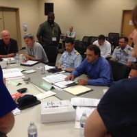 Participants around a table at spill drill.