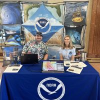 Two OR&R staff at a NOAA informational booth at the Hurricane Awareness Tour. 