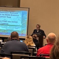 Panel speaker presents on "OR&R's Emergency Response Division and the NOAA Scientific Support Team" to a room of training attendees.