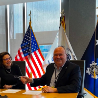 OR&R’s Director, Scott Lundgren, and USCG Director of Emergency Management, Dana Tulis, shake hands following the signing of the ERMA Interagency Agreement. 